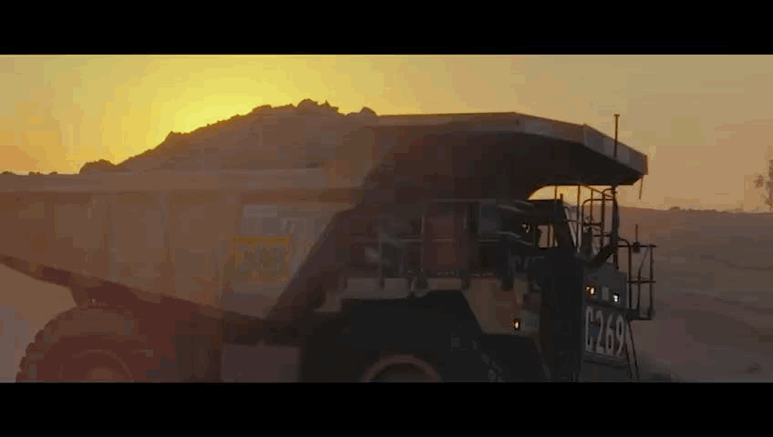 Mining truck on location at sunset